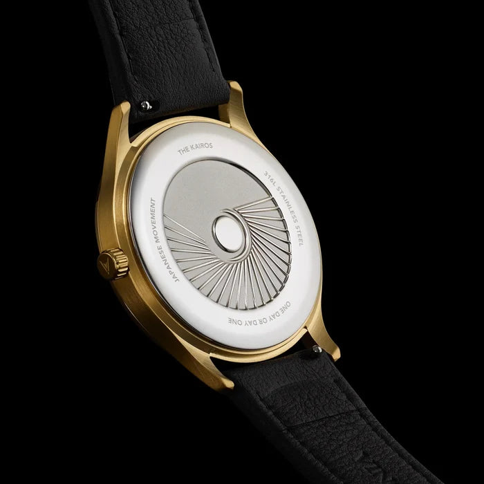 Watch with gold case and black strap on a black background