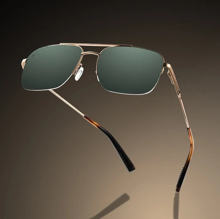Aviator sunglasses with gold frame and green lenses on a gradient background