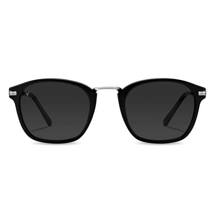 A pair of semi matte black sunglasses with smoke colored lenses and stainless steel temples.