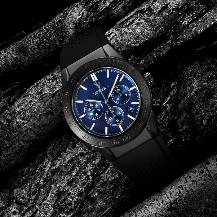 Black wristwatch with blue dial on a textured dark background
