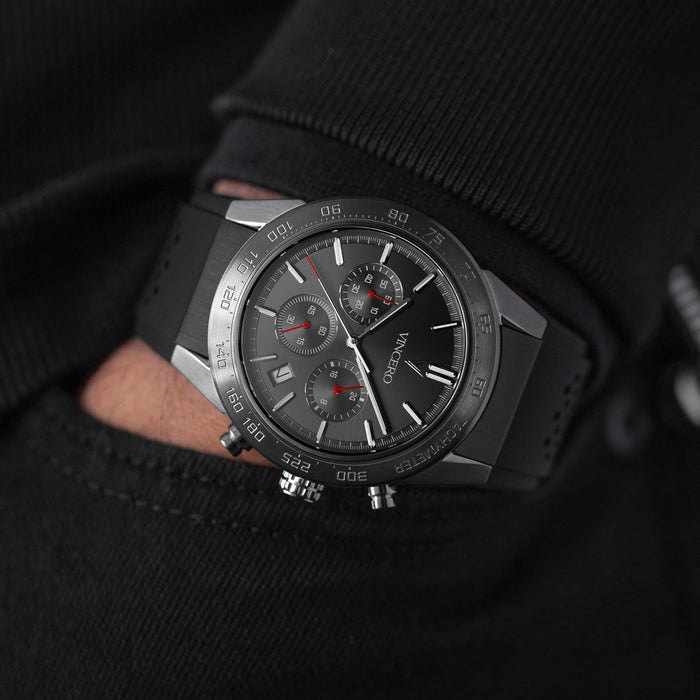 Black wristwatch with detailed face on a black background
