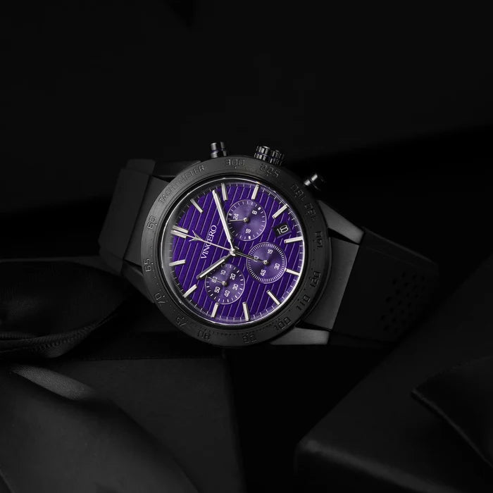 Luxury watch with a purple face on a dark background