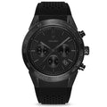 A matte black analog chronograph watch with a silicone band and a tachymeter on the dial.