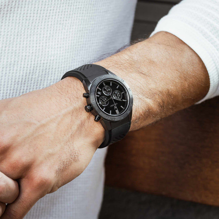 Black smartwatch on a person's wrist with a blurred background