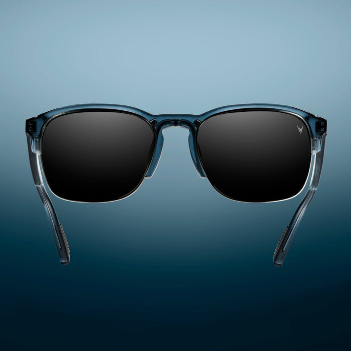 Sunglasses with dark lenses on a gradient blue background