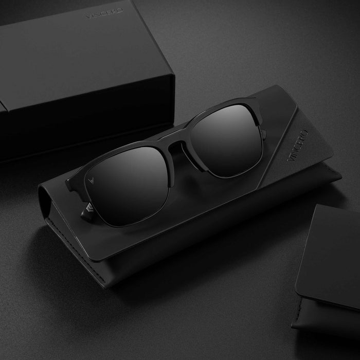 Black sunglasses with a case on a dark surface