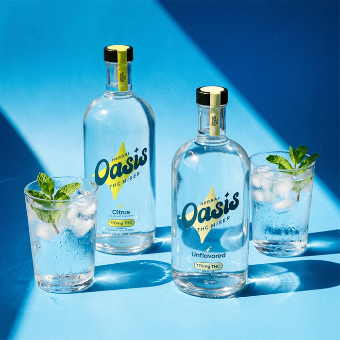 Two bottles of Herbal Oasis THC Mixer with two glasses filled with a clear liquid and ice on a blue background.; Flavor: Unflavored;