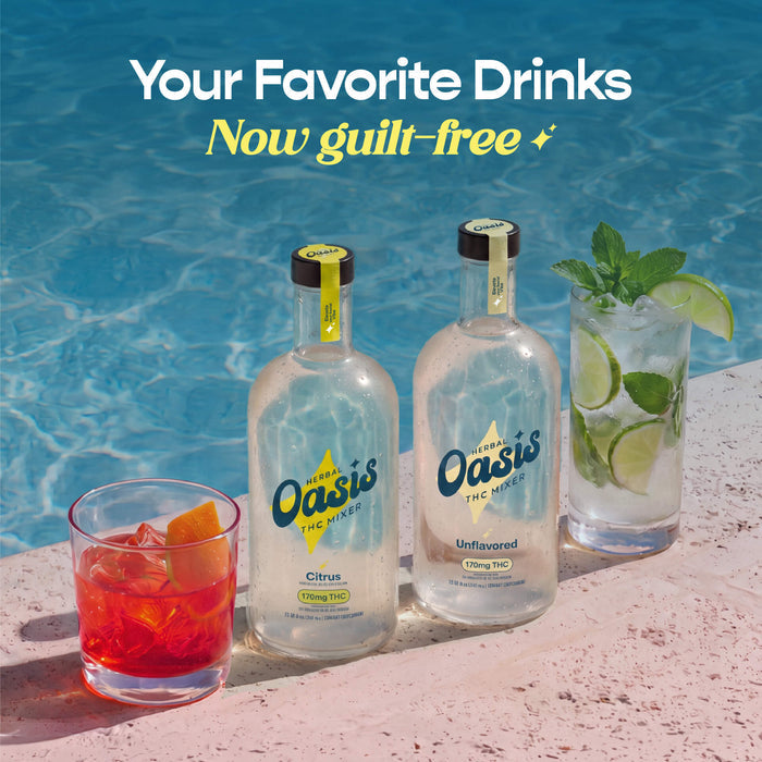 Two bottles of Oasis The Spirit non-alcoholic beer with lime and two glasses of cocktails on a poolside surface with blue water in the background. Text at the top reads 'Your Favorite Drinks Now guilt-free'.