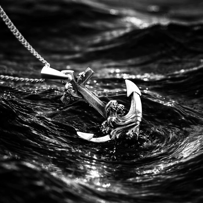 Silver anchor pendant with chain in water