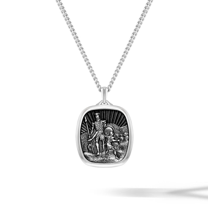 Silver pendant necklace with detailed design on a white background