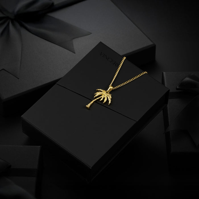 A gold palm tree pendant suspended from the box.