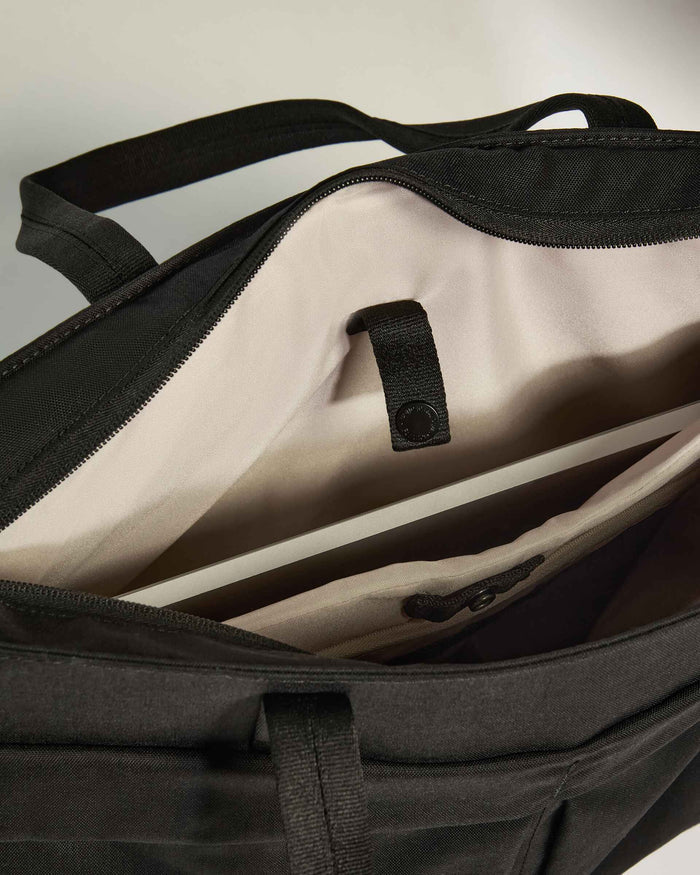 a black bag with a white strap
