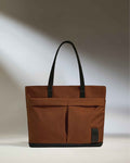 a brown bag with black handles