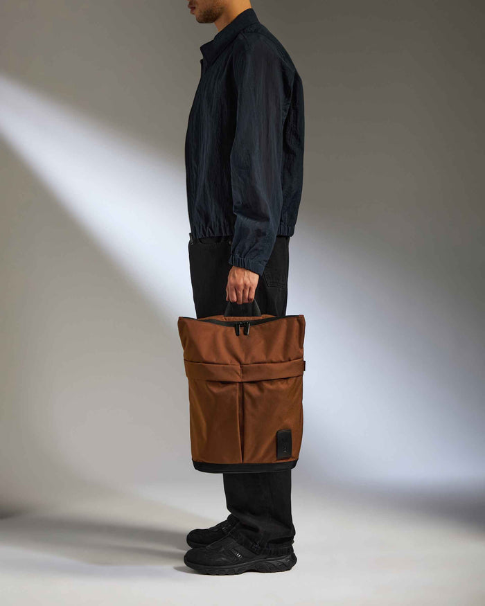 a man holding a brown bag