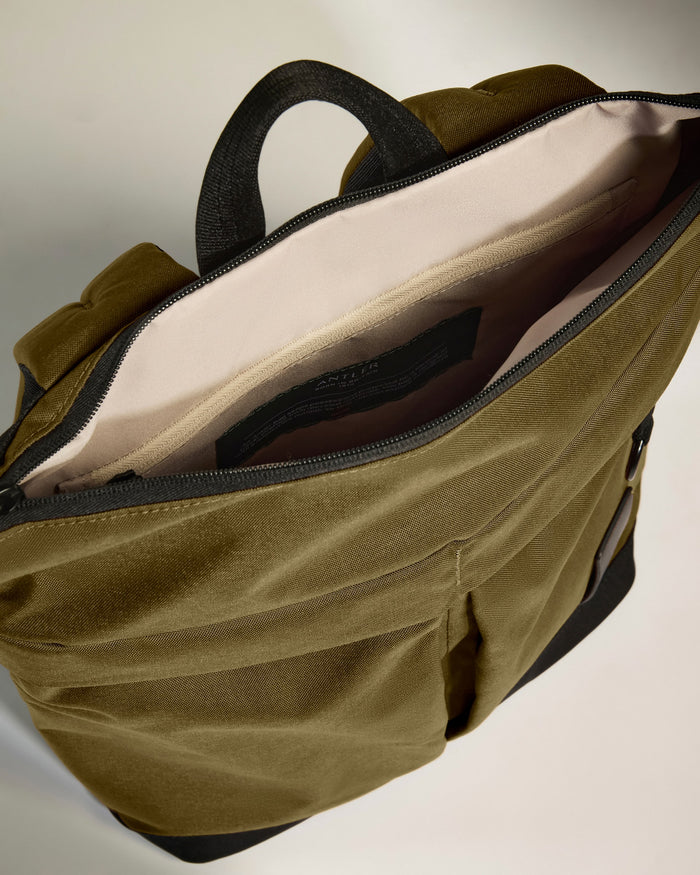 a green bag with a black handle