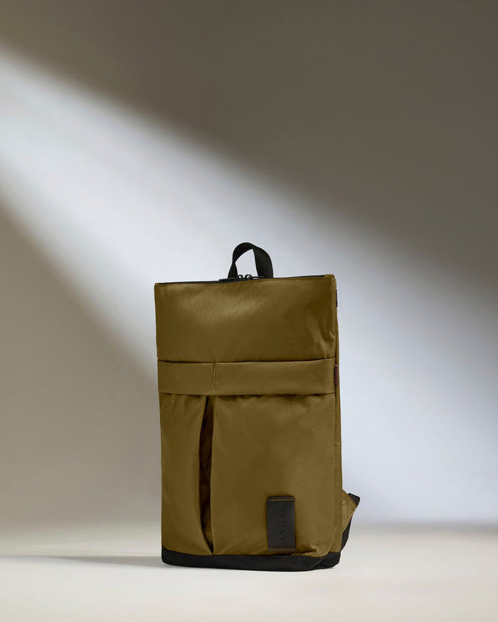 a brown backpack with a black strap