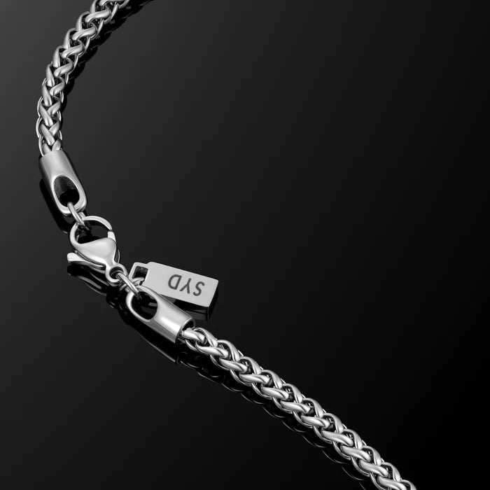 Silver chain bracelet with clasp on a black background